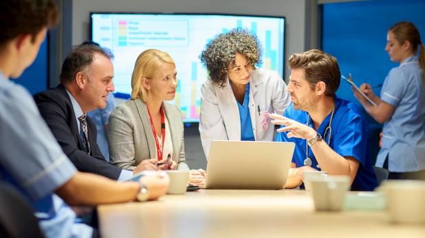 Hospital management meeting with doctors and senior managers